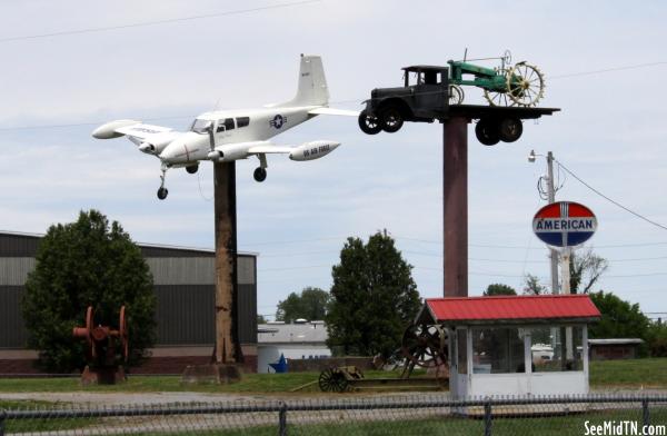 plane and tractor on poles