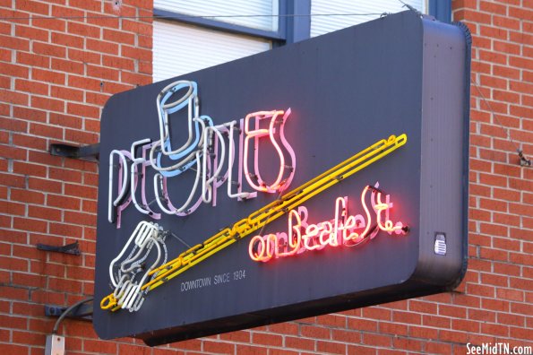 People on Beale St. neon sign